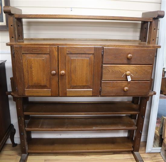 An oak cheese press bookcase fitted cupboards and drawers W.148cm